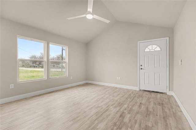 interior space featuring ceiling fan, light wood-type flooring, and vaulted ceiling