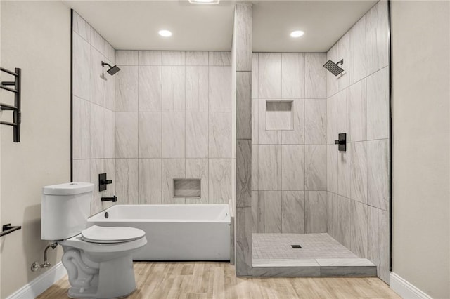 bathroom with toilet, wood-type flooring, and plus walk in shower