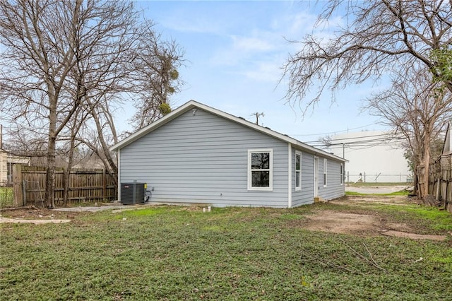 view of home's exterior with a yard and central AC