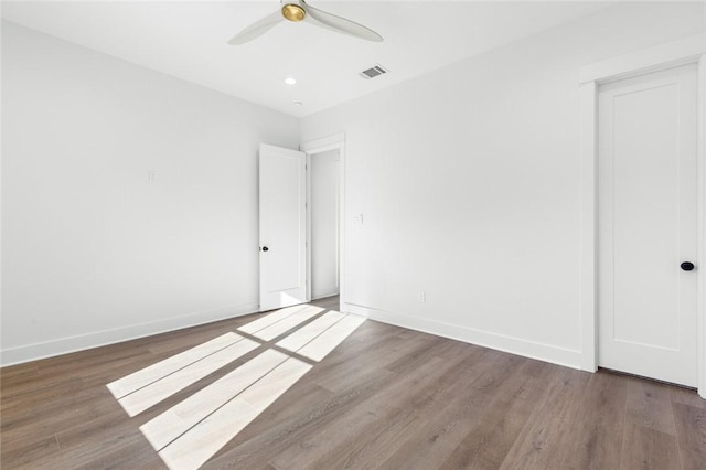 spare room featuring hardwood / wood-style floors and ceiling fan