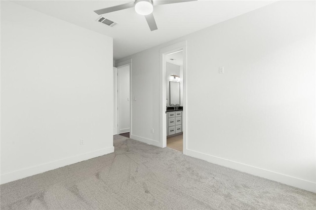 empty room featuring ceiling fan and light colored carpet