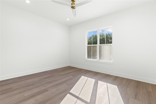 empty room with ceiling fan and wood-type flooring