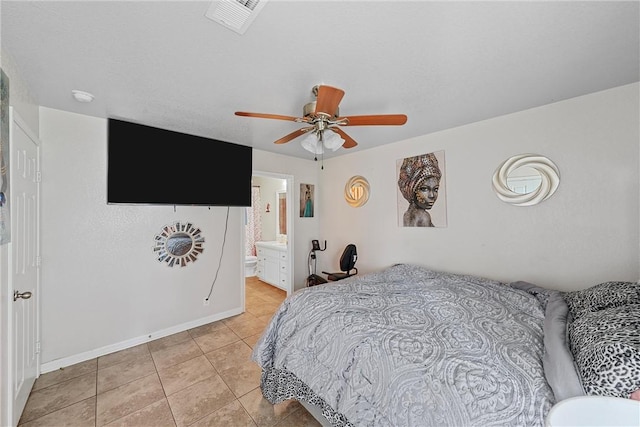 tiled bedroom with ceiling fan and ensuite bathroom