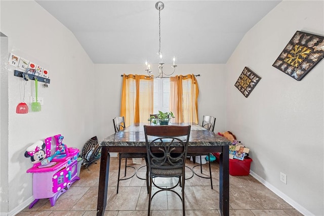 dining room with a chandelier and lofted ceiling