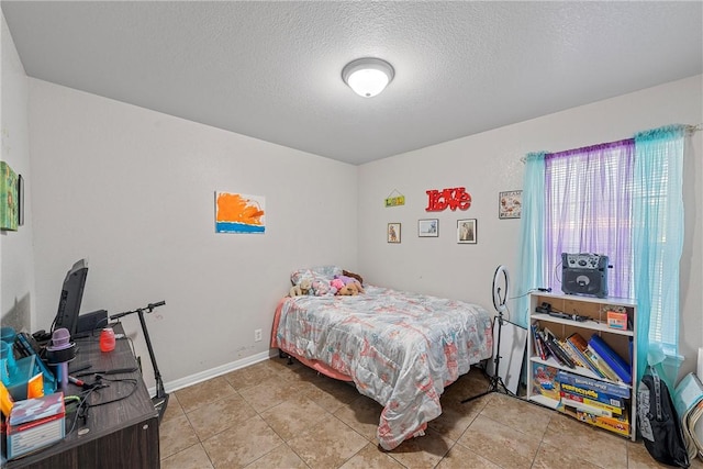 tiled bedroom with a textured ceiling