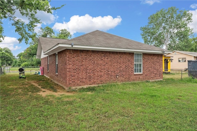 view of side of home featuring a yard