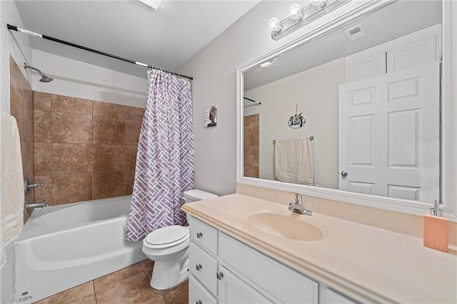 full bathroom featuring shower / bath combo, vanity, tile patterned flooring, toilet, and a textured ceiling