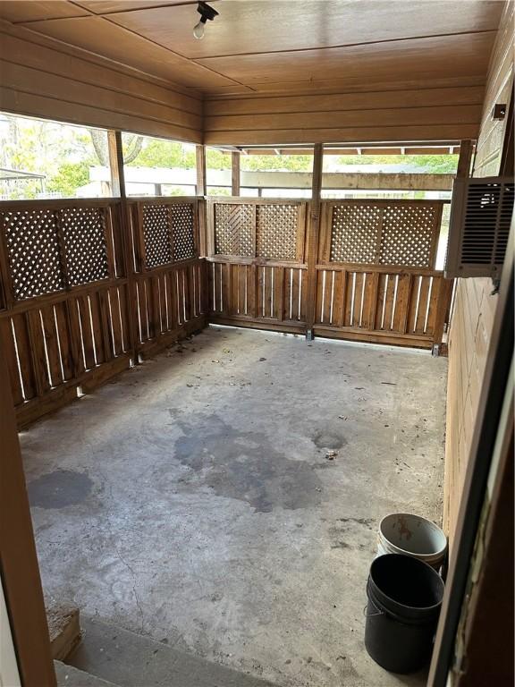 unfurnished sunroom with wooden ceiling