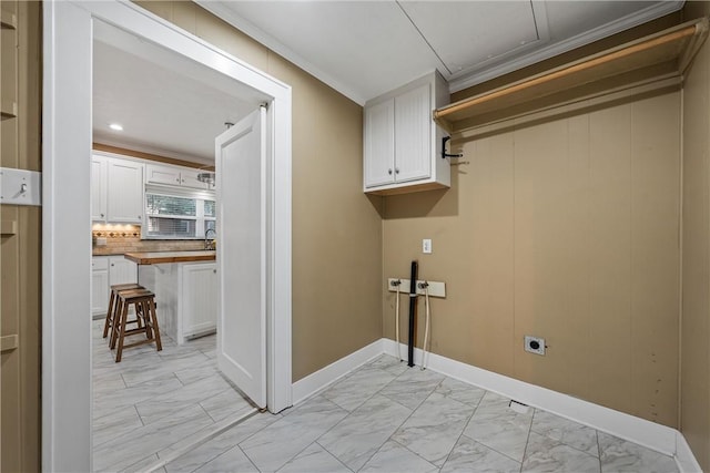 washroom featuring cabinets, crown molding, and electric dryer hookup