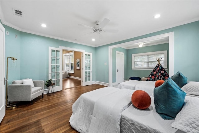 bedroom with french doors, dark hardwood / wood-style floors, ceiling fan, and ornamental molding