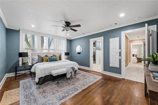 bedroom with hardwood / wood-style floors, ceiling fan, and ornamental molding