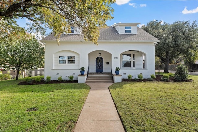 view of front of property with covered porch and a front yard