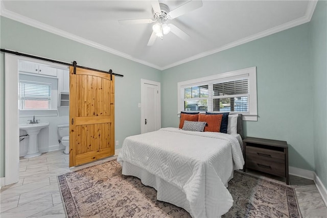 bedroom featuring ceiling fan, a barn door, ornamental molding, and ensuite bathroom