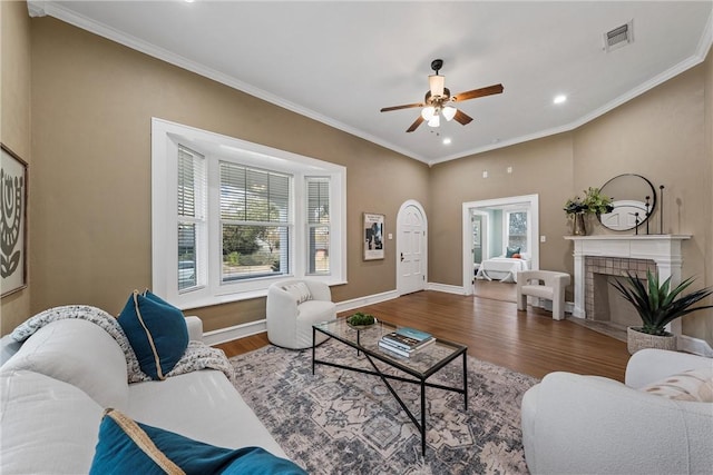 living room featuring ceiling fan, wood-type flooring, and ornamental molding