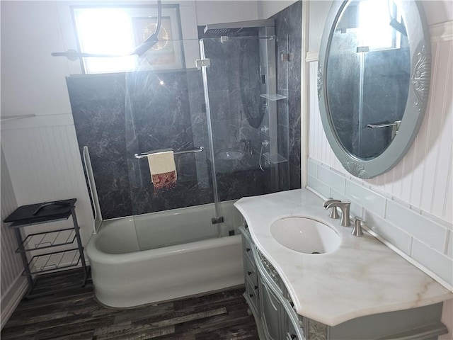 bathroom with wood-type flooring, vanity, and tiled shower / bath combo