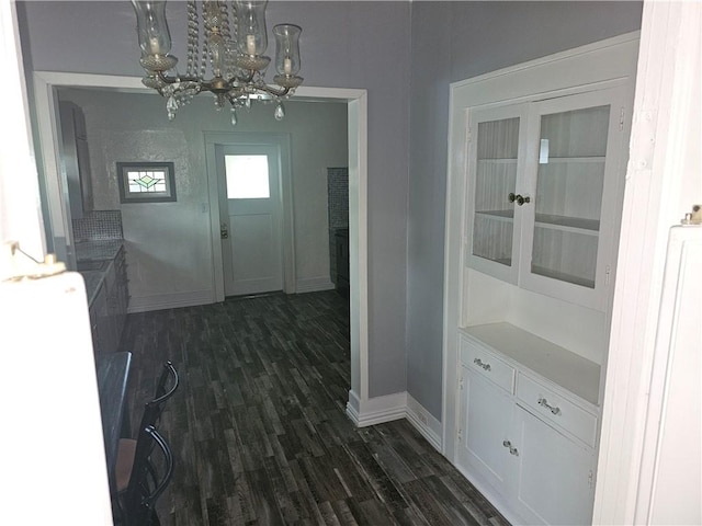 entryway with a chandelier and dark hardwood / wood-style flooring