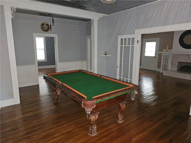 recreation room with a tile fireplace, wood-type flooring, and pool table