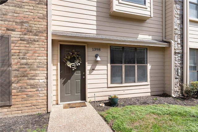 entrance to property with brick siding