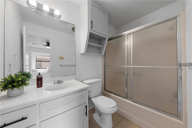 bathroom featuring a textured ceiling, ceiling fan, vanity, and tile patterned flooring