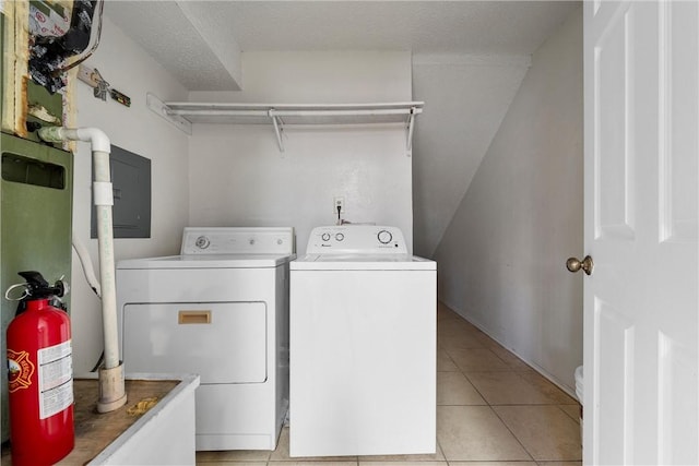 laundry area featuring light tile patterned floors, laundry area, and washer and clothes dryer