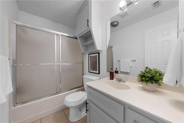 full bathroom with vanity, tile patterned floors, visible vents, and a textured ceiling