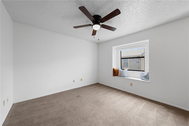 unfurnished room featuring a ceiling fan, baseboards, carpet floors, and a textured ceiling