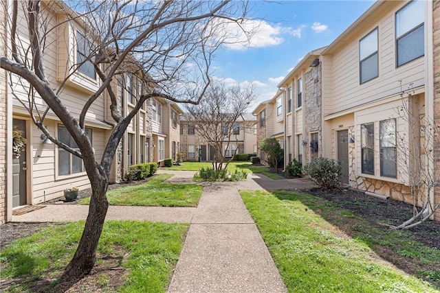 view of home's community with a yard and a residential view