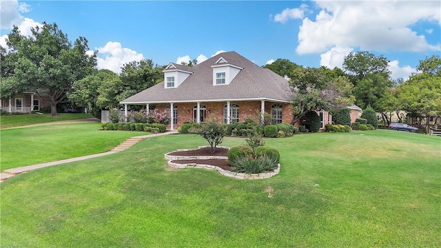 cape cod home with a front lawn and brick siding