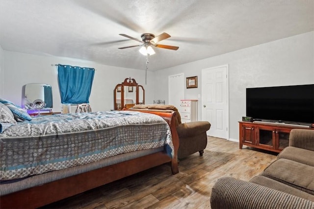 bedroom with hardwood / wood-style floors and ceiling fan