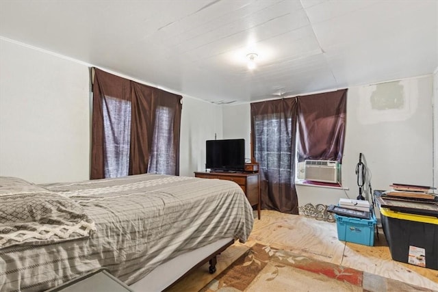 bedroom with hardwood / wood-style floors and cooling unit