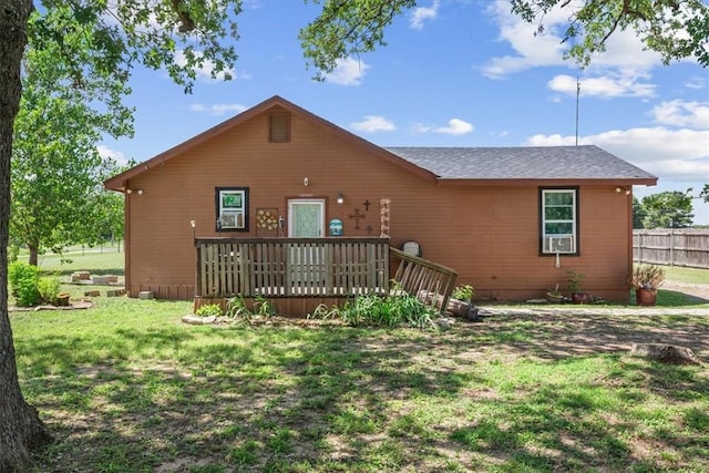 back of property featuring a lawn and a wooden deck