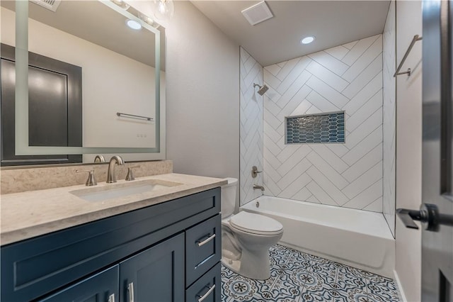 full bathroom with vanity, tiled shower / bath combo, tile patterned floors, and toilet