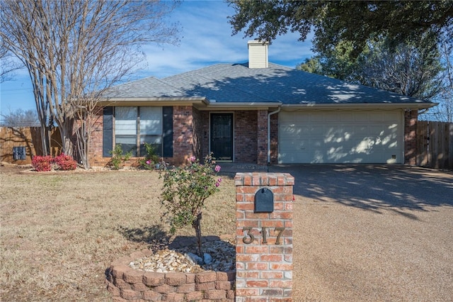 ranch-style house featuring a garage and a front lawn