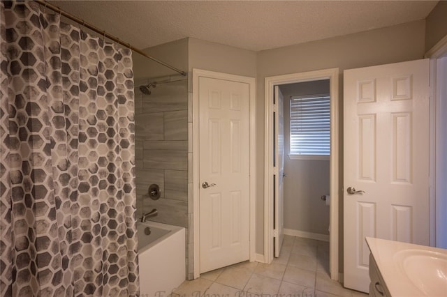 bathroom featuring a textured ceiling, vanity, shower / tub combo with curtain, and tile patterned flooring