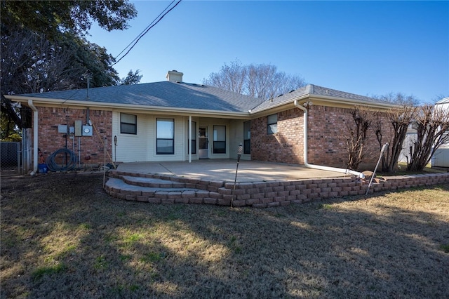 rear view of house with a patio area and a yard