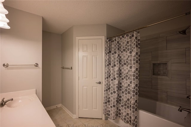 bathroom featuring vanity, shower / bath combination with curtain, a textured ceiling, and tile patterned flooring