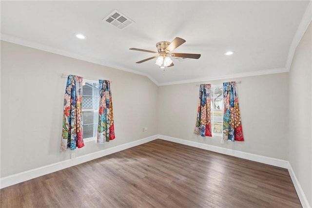 spare room featuring baseboards, visible vents, a ceiling fan, ornamental molding, and wood finished floors