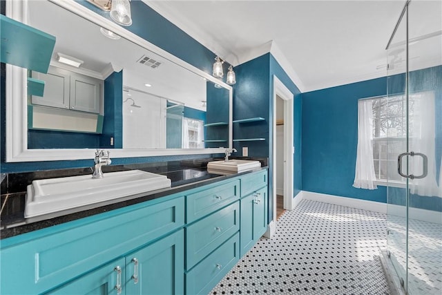 bathroom with ornamental molding, a sink, a shower stall, and double vanity