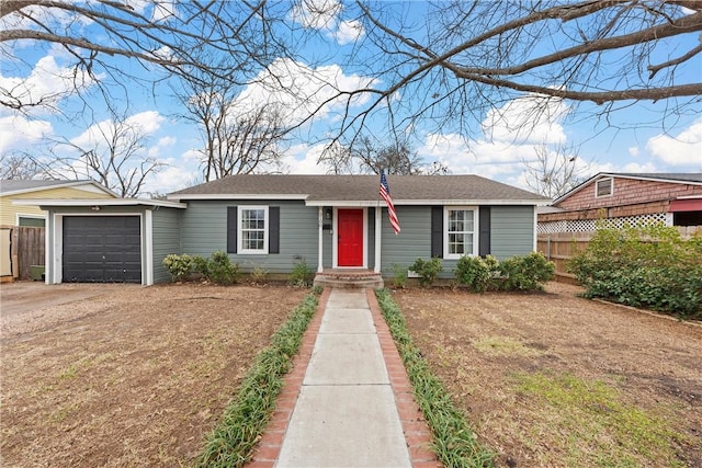 ranch-style home with an attached garage, driveway, and fence