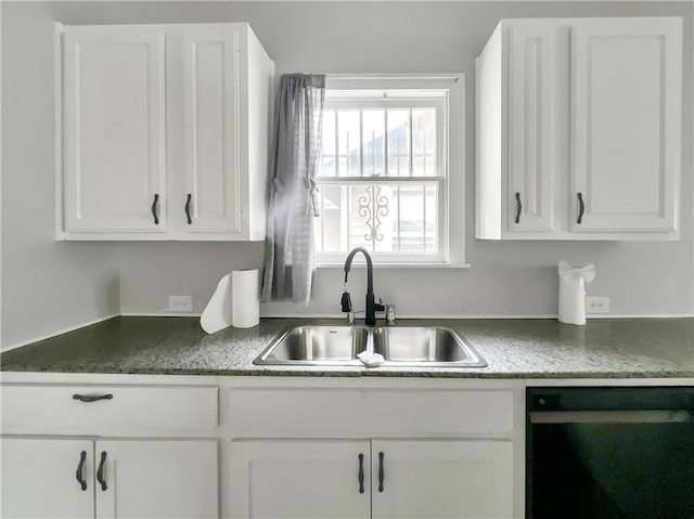 kitchen with white cabinets, black dishwasher, and sink