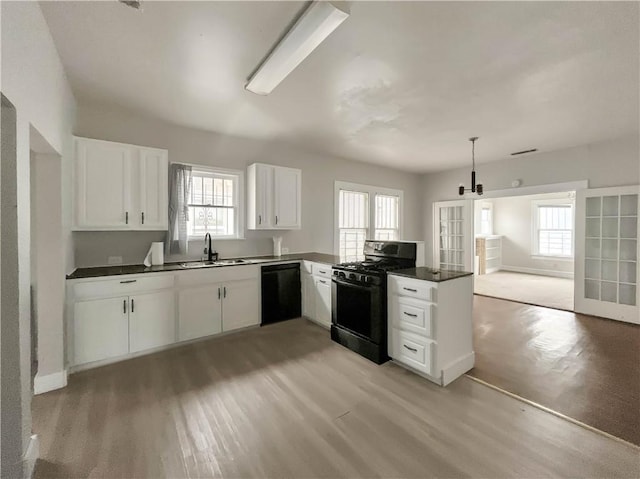 kitchen featuring white cabinets, sink, and black appliances