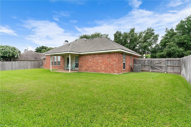 back of property featuring a lawn, a patio area, and central AC