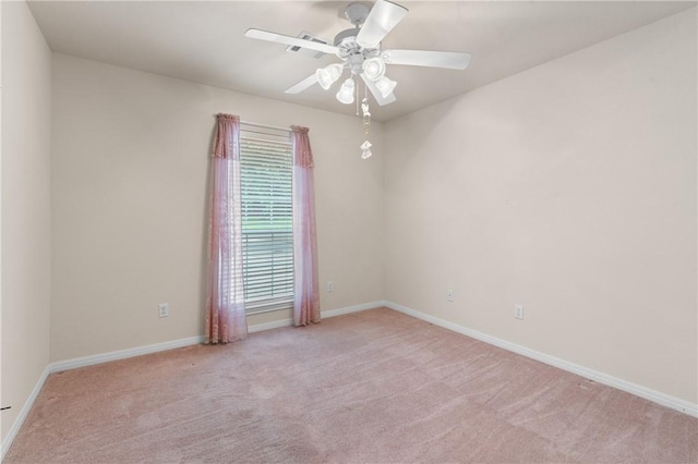 carpeted spare room with ceiling fan