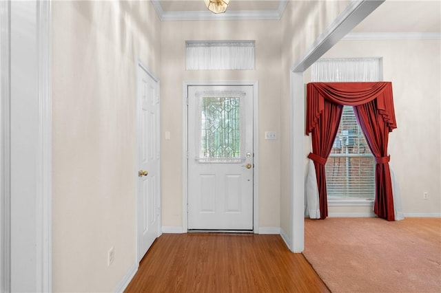 entryway with crown molding and hardwood / wood-style floors