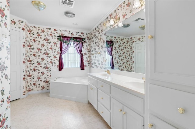 bathroom featuring a bath, vanity, and crown molding