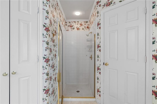 bathroom with tile patterned floors, ornamental molding, and walk in shower