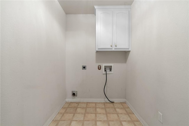 washroom featuring hookup for a washing machine, cabinets, and hookup for an electric dryer