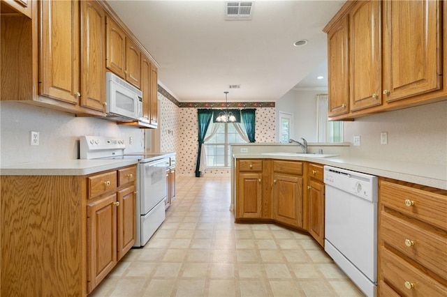 kitchen with white appliances, an inviting chandelier, sink, ornamental molding, and decorative light fixtures