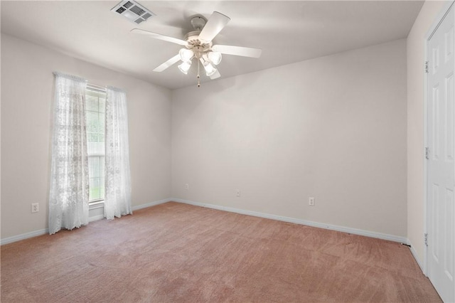 carpeted spare room featuring ceiling fan