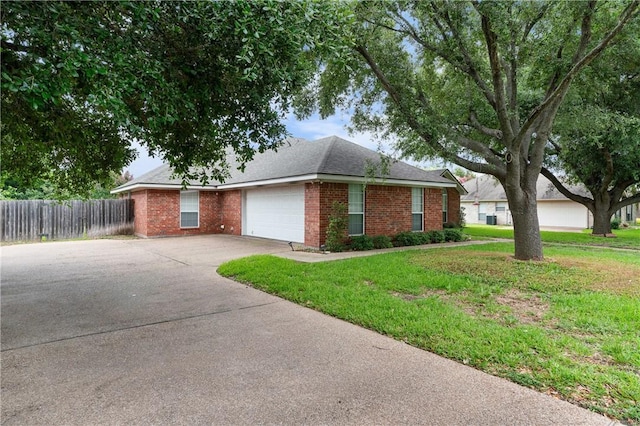 ranch-style home with a front lawn and a garage